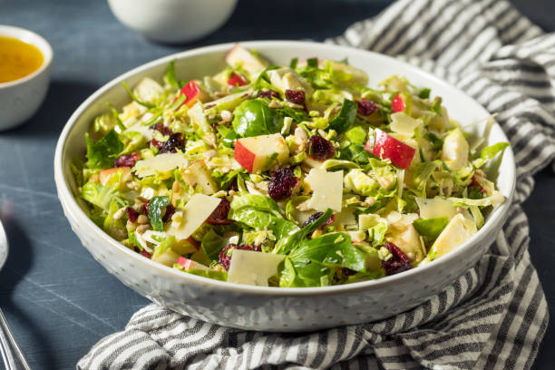 Healthy Fall Brussel Sprout Apple Salad Healthy Fall Brussel Sprout Apple Salad with Cheese and Dressing brussels sprout stock pictures, royalty-free photos & images