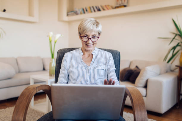 istock Senior teacher working from home online 1353897954