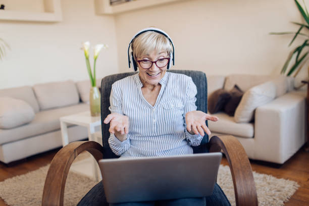 istock Senior teacher working from home online 1353897978