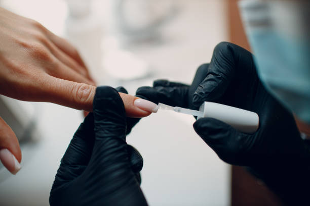 istock Manicure process female hands finger nails polish 1353899488
