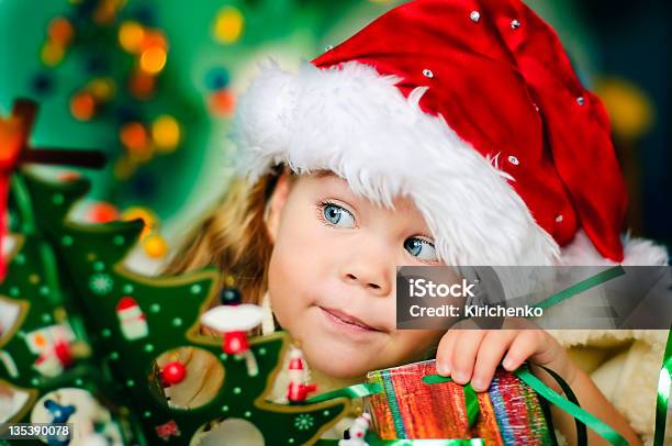 Girl Wearing Santa Hat At Christmas Time Stock Photo - Download Image Now - Christmas, Child, Beautiful People