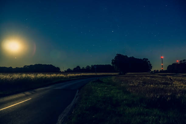istock A road next to fields in the dark. 1353904519