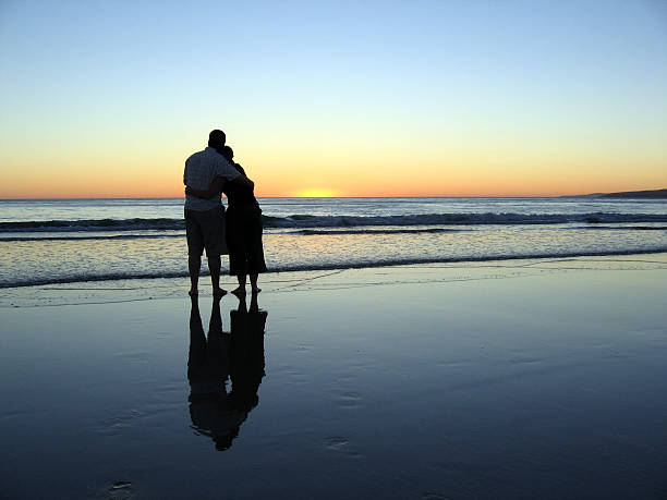 istock Couple Embracing on Beach at Sunset 135390853