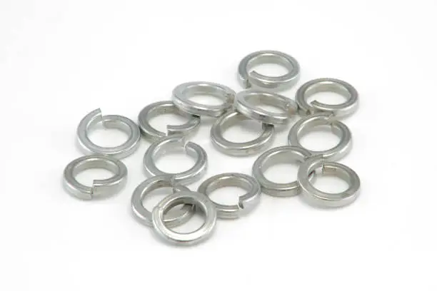Photo of Heap of 8mm split spring washers on white background