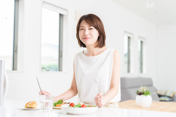 istock attractive asian woman who eats 1353913762