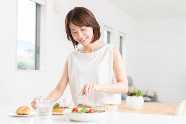 istock attractive asian woman who eats 1353913780