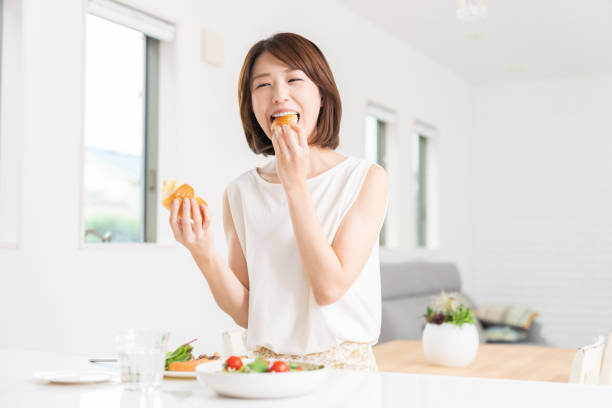 istock attractive asian woman who eats 1353913791
