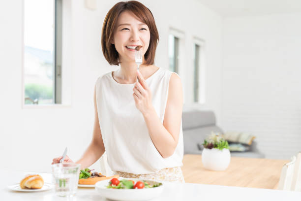 istock attractive asian woman who eats 1353913808