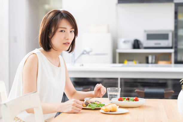 istock attractive asian woman who eats,no appetite 1353913817