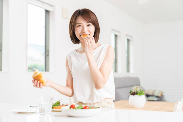 istock attractive asian woman who eats 1353913822