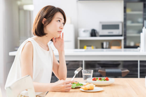 istock attractive asian woman who eats,no appetite 1353914292