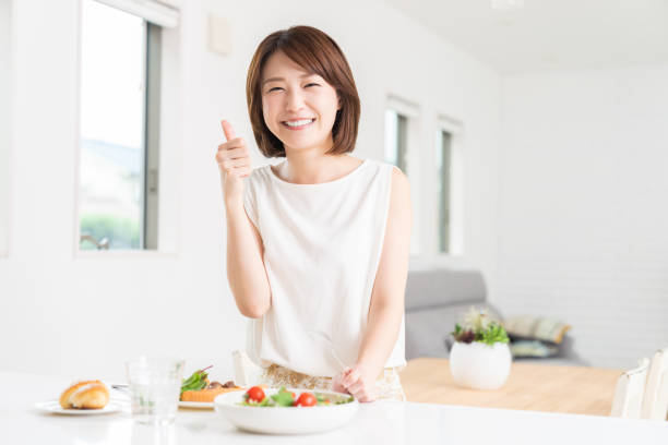 istock attractive asian woman who eats 1353914340