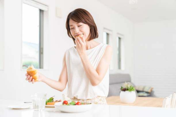istock attractive asian woman who eats 1353914343