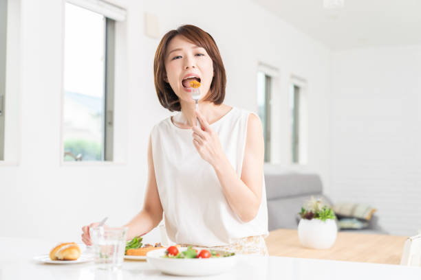 istock attractive asian woman who eats 1353914357
