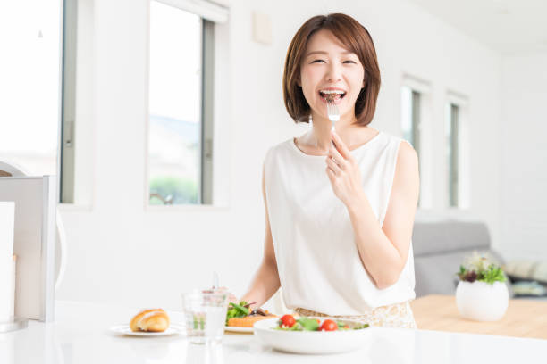 istock attractive asian woman who eats 1353914364