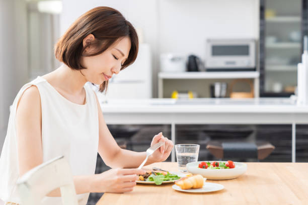 istock attractive asian woman who eats,no appetite 1353914369