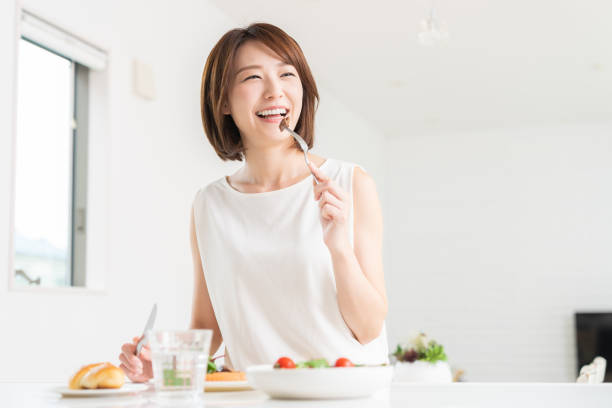 istock attractive asian woman who eats 1353914378