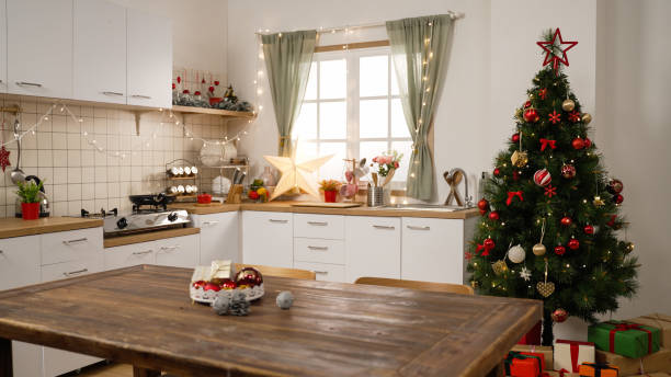 istock Beautiful interior with modern kitchen and christmas tree. New years eve celebration concept. empty room with star xmas decoration and lights on the wall in bright cooking place indoors 1353917449