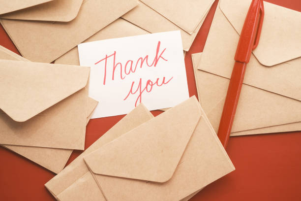 istock thank you message and envelope on wooden table 1353918719