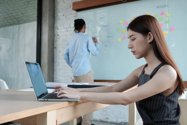 istock Two colleagues brainstorm and meeting business projects in an office. 1353920354