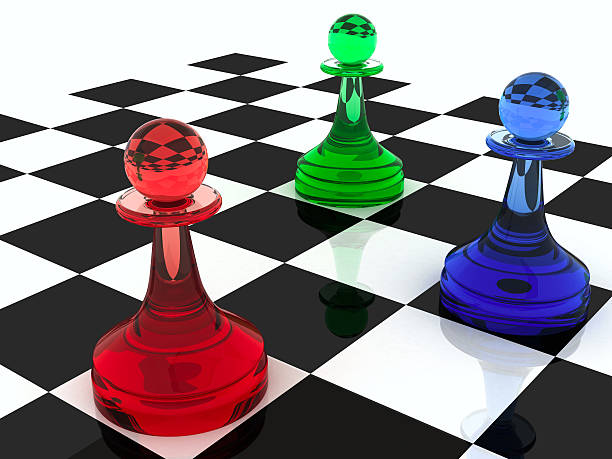 istock Three classical shape pawns made of different colored glass 135392357