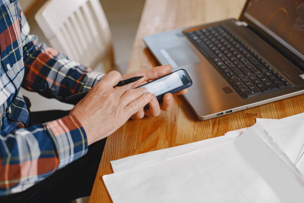 istock Senior man sitting at home at a table 1353924668
