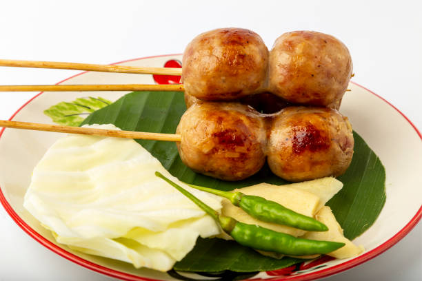 istock Isan sausage with side dishesfresh chili,fresh ginger,Cabbage.Place in a serving dish. 1353927358
