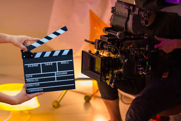 Man hands holding movie clapper. Film director concept. Behind the scenes of movie shooting or video production and film crew team stock photo