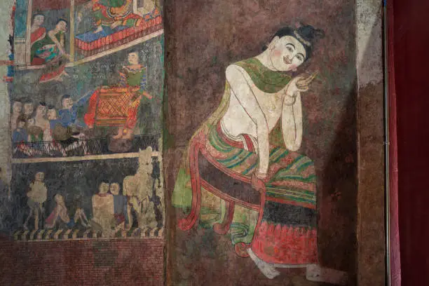 Photo of Ancient Buddhist temple mural depicting a Thai daily life scene at Wat Phumin