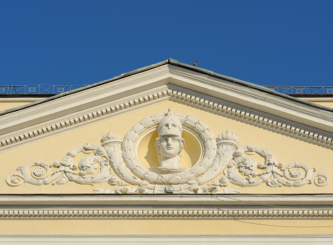 Fragment of old building facade with mascaron of Pallas Athena in Kyiv Ukraine