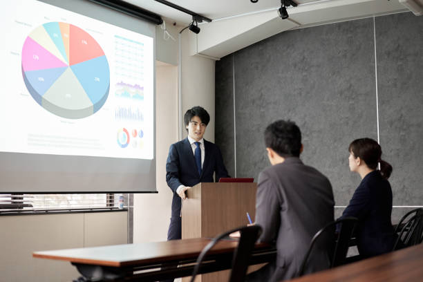 istock Asian businessman giving a presentation at a conference 1353938838