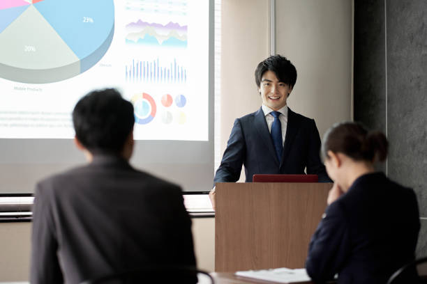 istock Asian businessman giving a presentation at a conference 1353938842