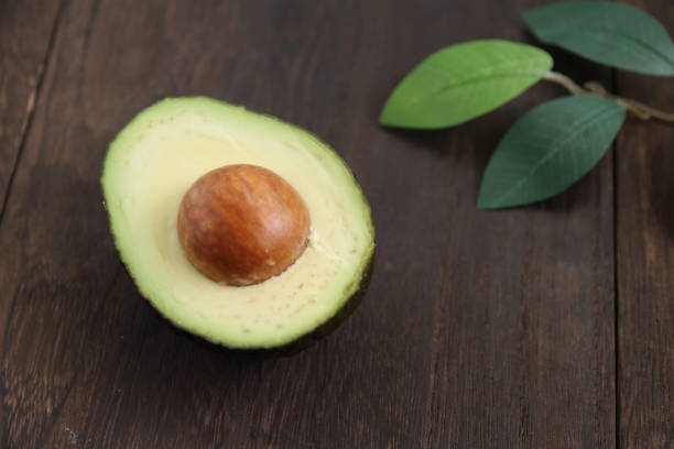 istock Avocado cut in half on a wooden table 1353943123