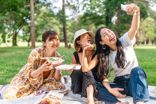 istock Friends taking selfies while enjoying having picnic in nature 1353945520