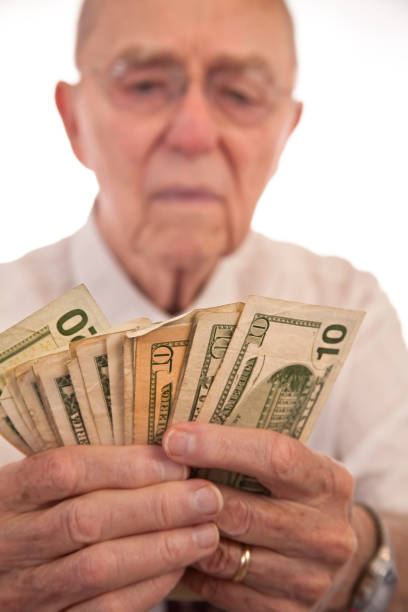 istock Senior man holding $10 bills 135394560