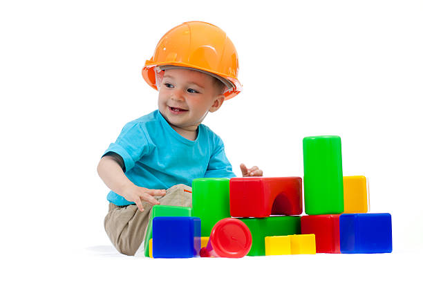 istock little boy with hard hat playing building blocks 135394674