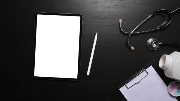 istock Top view digital tablet, clipboard and stethoscope on black background. 1353948636