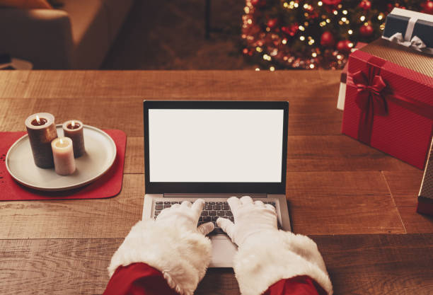 Santa Claus connecting with his laptop stock photo