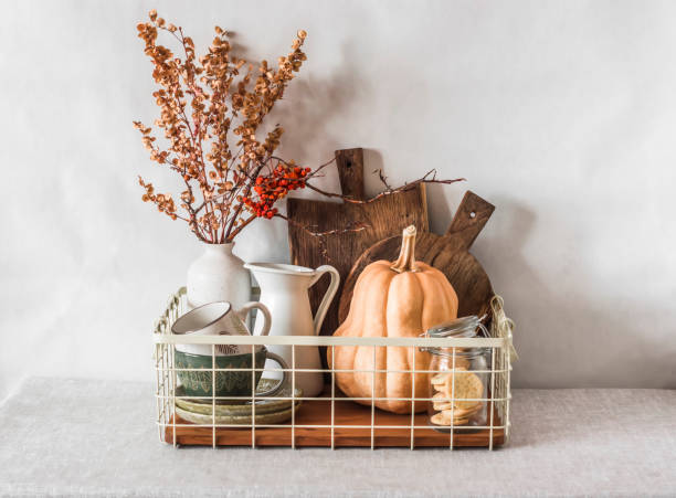 istock Kitchen interior - a basket with cutting boards, a jug, ceramic dishes on the table. Scandinavian style kitchen interior 1353953922