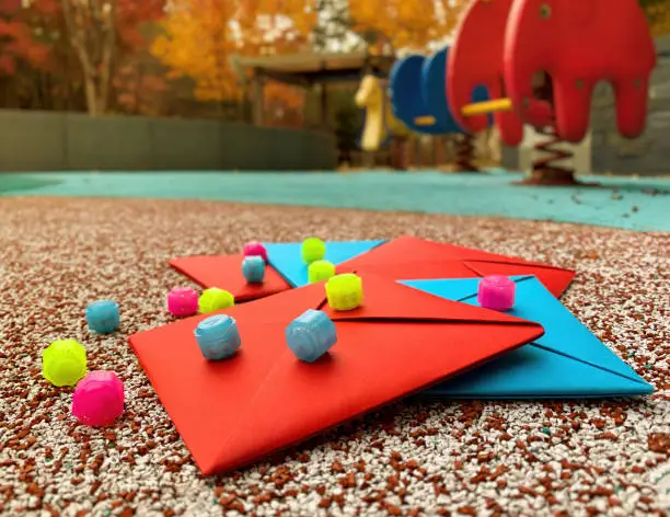 Photo of Korean traditional outdoor game tools on the playground. Gonggi and Ttakji.