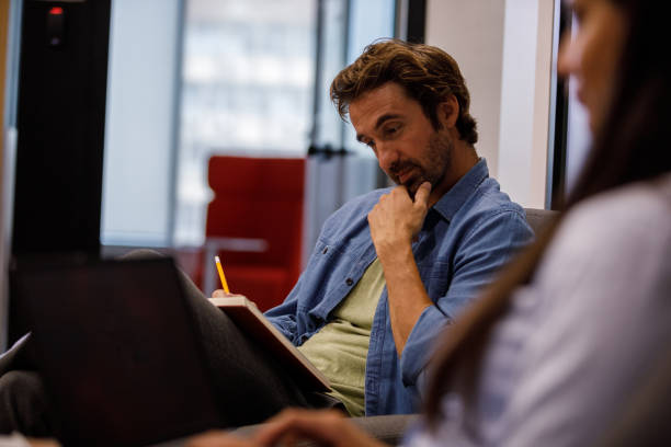 istock Selective focus shot of male entrepreneur reading project notes 1353958551