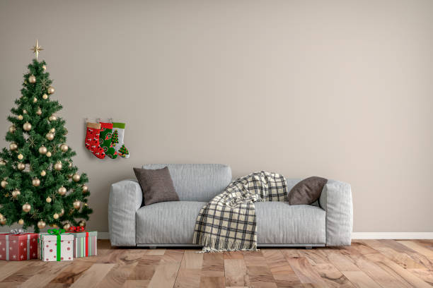 istock Empty simple living room with gray sofa, Christmas tree and gifts 1353960423
