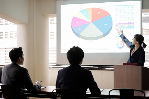 Asian business woman presenting at a conference