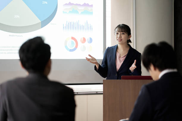 istock Asian business woman presenting at a conference 1353960595