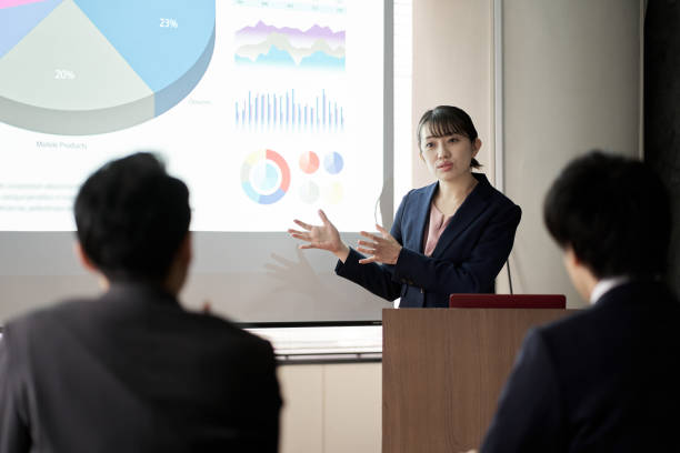 istock Asian business woman presenting at a conference 1353960642