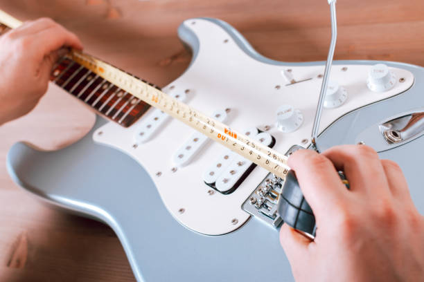 istock Guitar master doing guitar scale measurement for saddle adjustment 1353961473