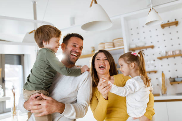 istock Cheerful parents having fun with their kids at home. 1353962673