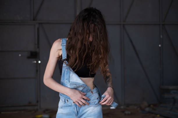 istock Young Woman Wearing Overalls 1353965393
