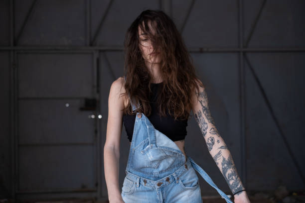 istock Young Woman Wearing Overalls 1353965396