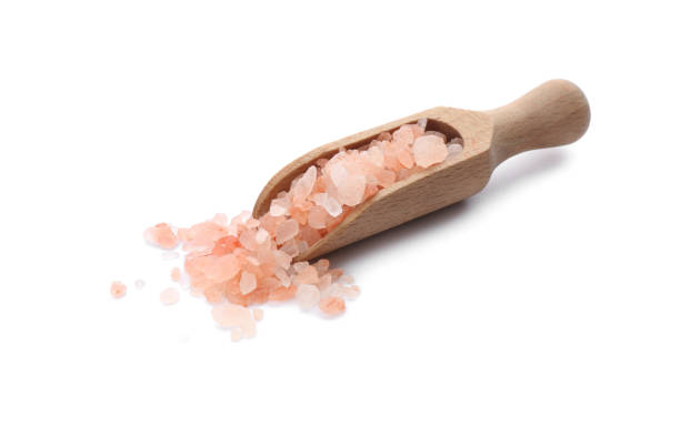 istock Wooden scoop with pink himalayan salt isolated on white 1353965875
